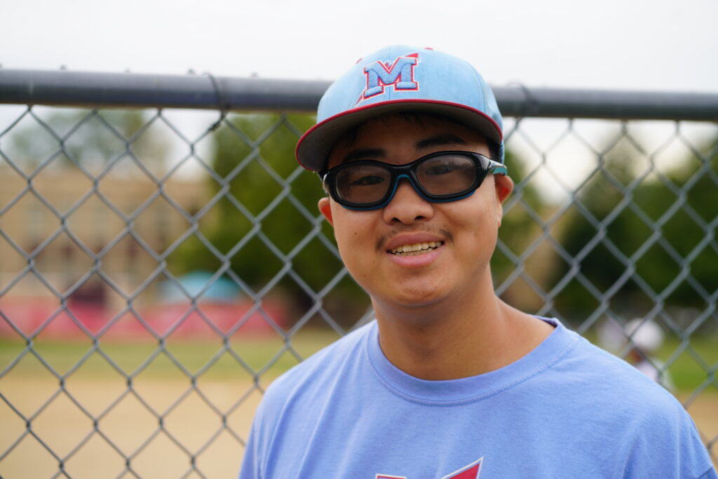 Taber at the baseball field, where an interest in coaching has become an assistant coaching opportunity.